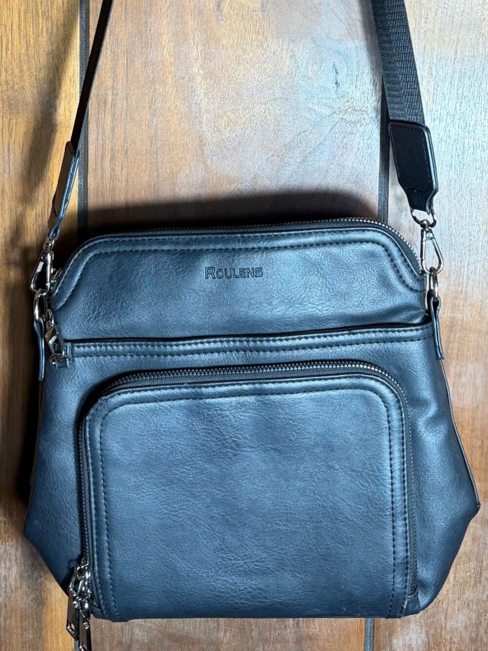 Roulens Black Faux Leather Crossbody Bag Purse Front Zip Pocket &Embossed Logo